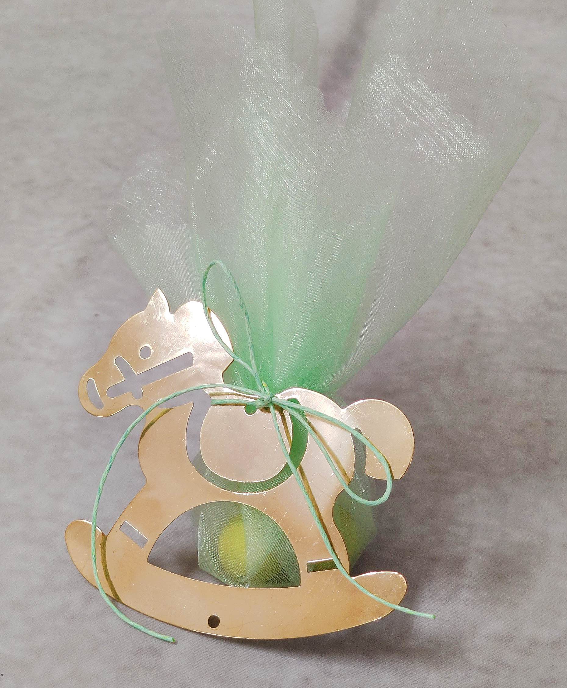 Μπομπονιέρα βάπτισης με χρυσό μεταλλικό αλογάκι σε μέντα αποχρώσεις.