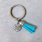 Μαρτυρικά βάπτισης μπρελόκ με γαλάζια δερμάτινη φούντα και κωνσταντινάτο σε κουτί 25 τεμαχίων. 