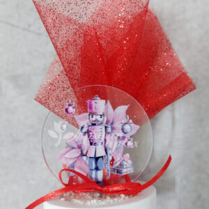 Χριστουγενιάτικη μπομπονιέρα plexiglass με θέμα καρυοθραύστης σε βότσαλο.