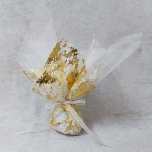 Μπομπονιέρα γάμου με δίχτυ με φύλλο χρυσού και λευκή οργάντζα εσωτερικά, δεμένη με λευκή κορδέλα οργάντζας.