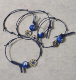 Μαρτυρικά βάπτισης βραχιόλια με ξύλινο ζωγραφισμένο μάτι και περίτεχνο σταυρό ασημί κωνσταντινάτο και μπλέ στρας.