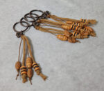 Μαρτυρικά βάπτισης κομπολόι - μπρελόκ Boho με σχοινιά ξύλινες χάντρες και μεταλλικό σταυρό.